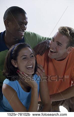 Portrait of two young men and a young woman smiling View Large Photo Image Stock Image - Portrait of two young men and a young woman smiling. Fotosearch