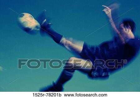 Side profile of a soccer player in mid-air kicking a soccer ball View Large Photo Image Stock Image - Side profile of a soccer player in mid-air kicking a soccer ball. Fotosearch