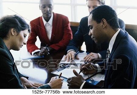 Two businessmen and two businesswomen in an office View Large Photo Image Stock Image - Two businessmen and two businesswomen in an office. Fotosearch