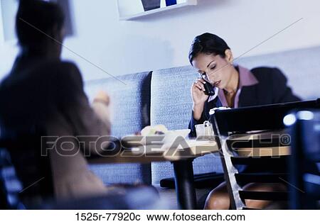 Two businesswomen in a cafe View Large Photo Image Stock Image - Two businesswomen in a cafe. Fotosearch