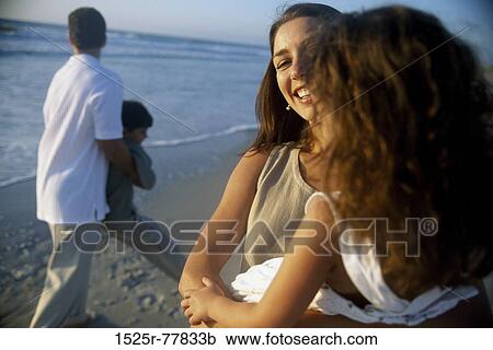 Young couple on the beach with their son and daughter View Large Photo Image Stock Image - Young couple on the beach with their son and daughter. Fotosearch