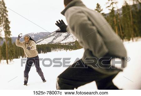 Young couple throwing snowballs View Large Photo Image Stock Image - Young couple throwing snowballs. Fotosearch