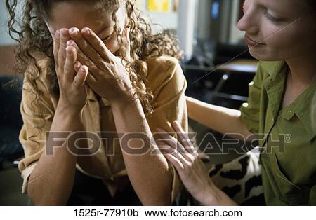 Young woman consoling another View Large Photo Image Stock Image - Young woman consoling another. Fotosearch