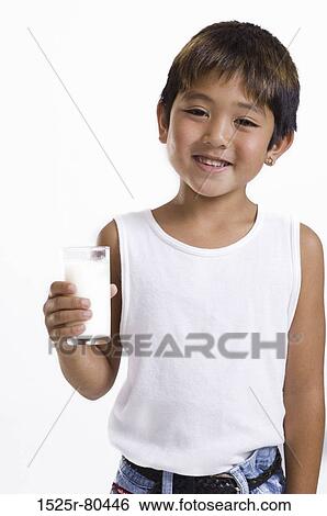 Close-up of a boy holding a glass of milk View Large Photo Image Stock Photograph - Close-up of a boy holding a glass of milk. Fotosearch