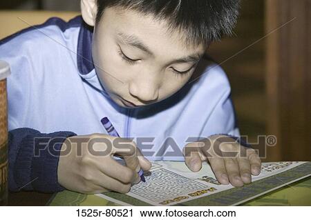 Close-up of a boy working a puzzle View Large Photo Image Stock Image - Close-up of a boy working a puzzle. Fotosearch