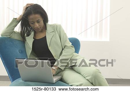 Close-up of a businesswoman using a laptop View Large Photo Image Stock Image - Close-up of a businesswoman using a laptop. Fotosearch