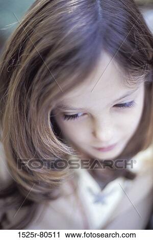 Stock Image - Close-up of a girl looking serious. Fotosearch