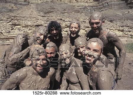 Close-up of a group of people covered with mud smiling View Large Photo Image Stock Photo - Close-up of a group of people covered with mud smiling. Fotosearch