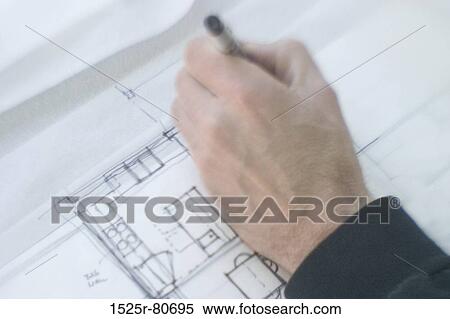 Stock Photography - Close-up of a human hand making a blueprint. Fotosearch