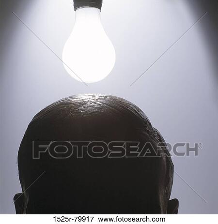 Close-up of a lit up bulb above a person's head View Large Photo Image Stock Photo - Close-up of a lit up bulb above a person's head. Fotosearch