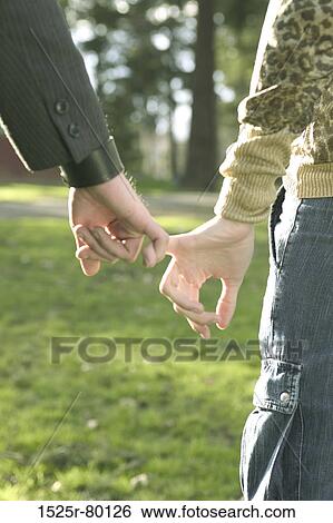 Close-up of a man and a woman holding hands View Large Photo Image Stock Photograph - Close-up of a man and a woman holding hands. Fotosearch