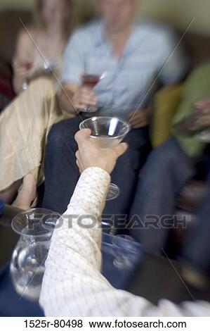 Close-up of a man toasting with his friends View Large Photo Image Stock Photo - Close-up of a man toasting with his friends. Fotosearch