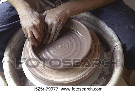 Stock Photo - Close-up of a man working on a pottery wheel. Fotosearch