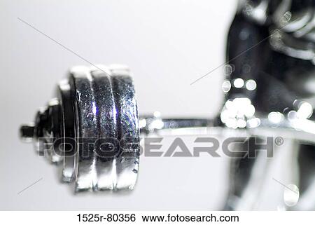 Close-up of a metal statue of a person's hands holding a barbell View Large Photo Image Stock Photograph - Close-up of a metal statue of a person's hands holding a barbell. Fotosearch