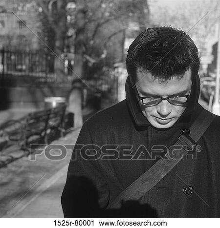 Close-up of a mid adult man looking down View Large Photo Image Stock Image - Close-up of a mid adult man looking down. Fotosearch