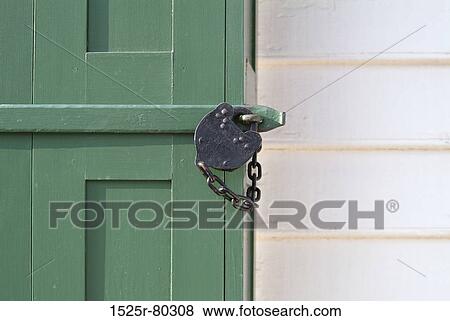 Close-up of a padlock on a door View Large Photo Image Stock Photo - Close-up of a padlock on a door. Fotosearch