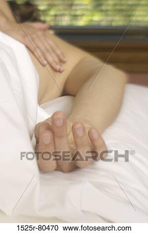 Close-up of a person getting a back massage from a massage therapist View Large Photo Image Stock Image - Close-up of a person getting a back massage from a massage therapist. Fotosearch
