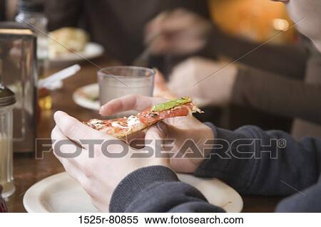 Close-up of a person's hand holding a pizza View Large Photo Image Stock Photography - Close-up of a person's hand holding a pizza. Fotosearch