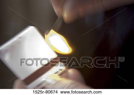 Close-up of a person's hand lighting a matchstick View Large Photo Image Picture - Close-up of a person's hand lighting a matchstick. Fotosearch