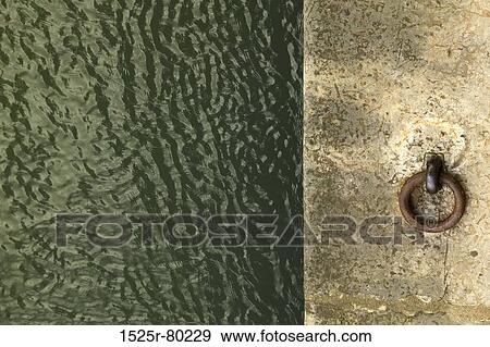 Stock Photo - Close-up of a ring on a cement structure. Fotosearch