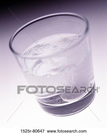 Close-up of a tablet dissolving a glass of water View Large Photo Image Stock Photo - Close-up of a tablet dissolving a glass of water. Fotosearch