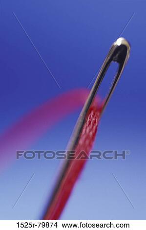 Close-up of a thread in the eye of a needle View Large Photo Image Picture - Close-up of a thread in the eye of a needle. Fotosearch