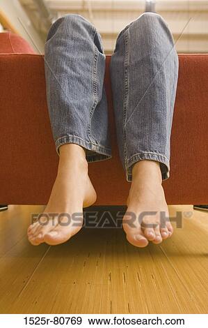 Close-up of a woman's legs on a couch View Large Photo Image Stock Photo - Close-up of a woman's legs on a couch. Fotosearch
