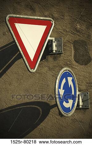 Close-up of a yield sign and a traffic circle on the wall View Large Photo Image Stock Photo - Close-up of a yield sign and a traffic circle on the wall. Fotosearch