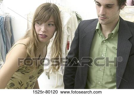 Close-up of a young couple in a clothing store View Large Photo Image Stock Image - Close-up of a young couple in a clothing store. Fotosearch