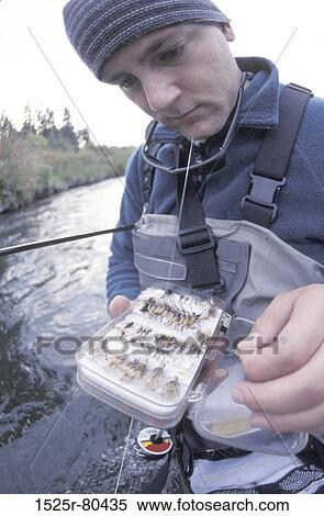 Close-up of a young man holding a box of fishing bait View Large Photo Image Stock Photography - Close-up of a young man holding a box of fishing bait. Fotosearch