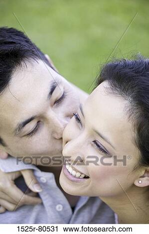 Close-up of a young man kissing a young woman View Large Photo Image Stock Image - Close-up of a young man kissing a young woman. Fotosearch