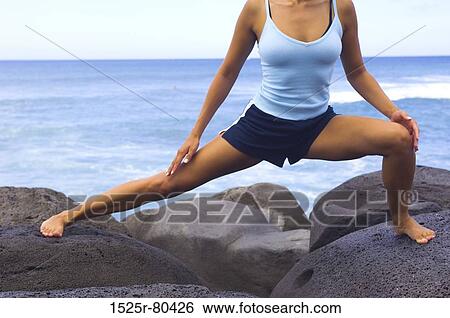 Close-up of a young woman exercising View Large Photo Image Stock Photograph - Close-up of a young woman exercising. Fotosearch