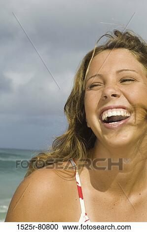 Close-up of a young woman laughing View Large Photo Image Stock Image - Close-up of a young woman laughing. Fotosearch