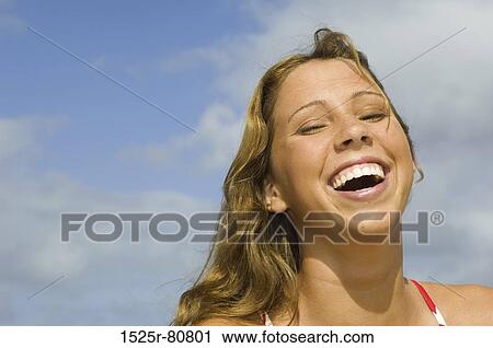 Stock Image - Close-up of a young woman laughing. Fotosearch