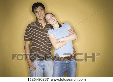 Close-up of a young woman leaning against a young man View Large Photo Image Stock Photo - Close-up of a young woman leaning against a young man. Fotosearch