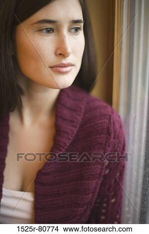 Close-up of a young woman looking away View Large Photo Image Picture - Close-up of a young woman looking away. Fotosearch