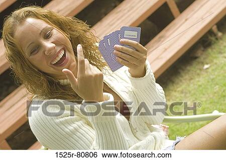 Close-up of a young woman playing cards and laughing View Large Photo Image Stock Photograph - Close-up of a young woman playing cards and laughing. Fotosearch