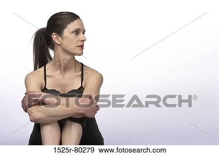 Close-up of a young woman sitting View Large Photo Image Stock Photo - Close-up of a young woman sitting. Fotosearch