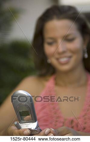 Close-up of a young woman using a mobile phone View Large Photo Image Picture - Close-up of a young woman using a mobile phone. Fotosearch