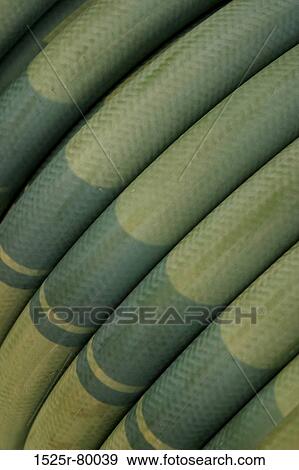 Close-up of coiled green hose View Large Photo Image Stock Photo - Close-up of coiled green hose. Fotosearch