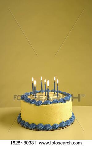 Close-up of lit up candles on a birthday cake View Large Photo Image Stock Image - Close-up of lit up candles on a birthday cake. Fotosearch