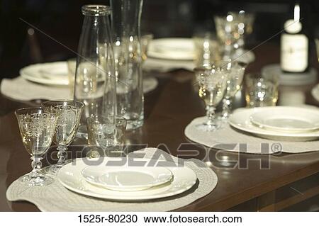 Close-up of stem glasses and plates on a dining table View Large Photo Image Stock Image - Close-up of stem glasses and plates on a dining table. Fotosearch