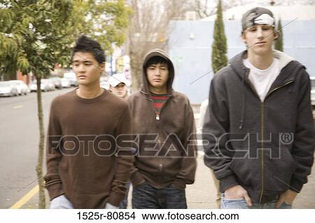 Close-up of three teenage boys walking View Large Photo Image Picture - Close-up of three teenage boys walking. Fotosearch