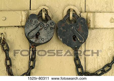 Close-up of two padlocks on a door View Large Photo Image Stock Image - Close-up of two padlocks on a door. Fotosearch