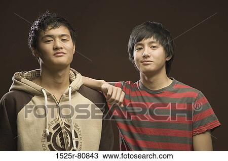 Close-up of two teenage boys smirking View Large Photo Image Stock Image - Close-up of two teenage boys smirking. Fotosearch