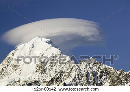 Cloud over a snow covered mountain View Large Photo Image Stock Image - Cloud over a snow covered mountain. Fotosearch