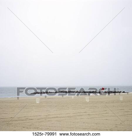 Stock Image - Empty beach chairs on the beach. Fotosearch