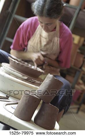 Female potter working on a pottery wheel View Large Photo Image Stock Photography - Female potter working on a pottery wheel. Fotosearch
