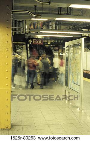 Stock Image - Group of people standing on a subway station. Fotosearch