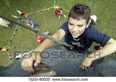 High angle view of a boy rock climbing View Large Photo Image Stock Image - High angle view of a boy rock climbing. Fotosearch